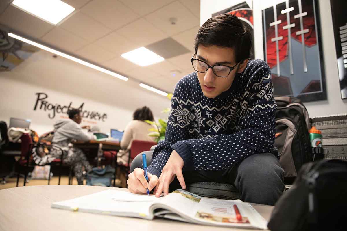 A student works on a school project inside the Project Achieve offices.