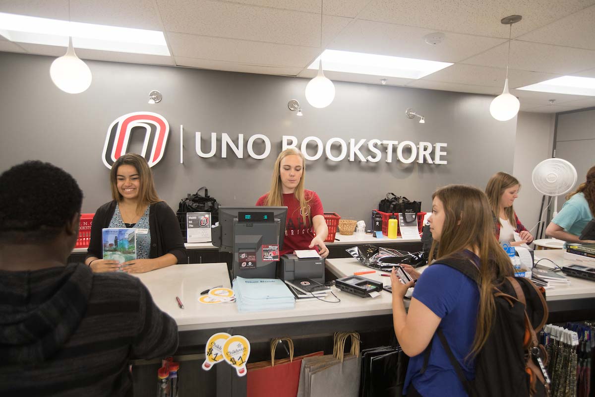 Student workers in the UNO Bookstore helps sell books.