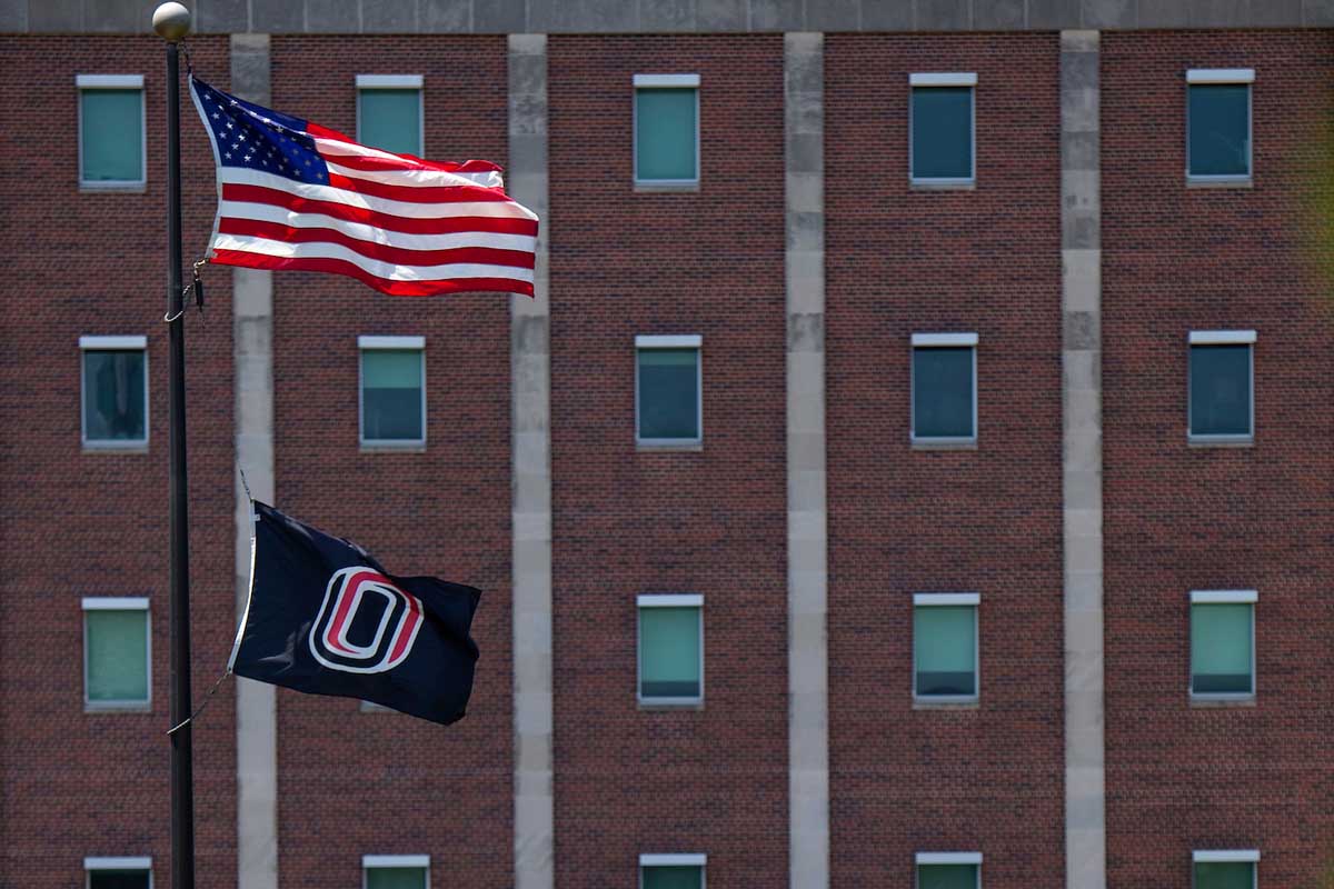 A photo of the UNO flag lowered on the Dodge Campus.