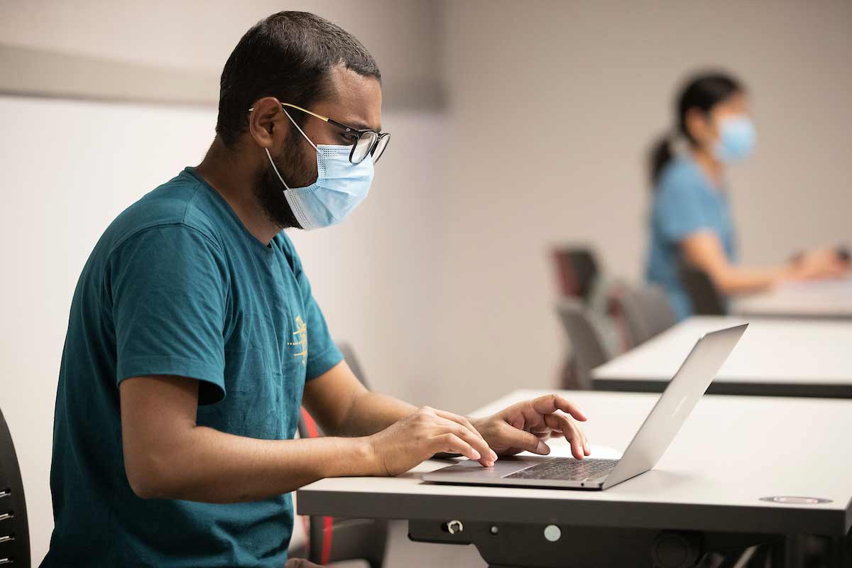 A student works at his computer during an IT Innovation class