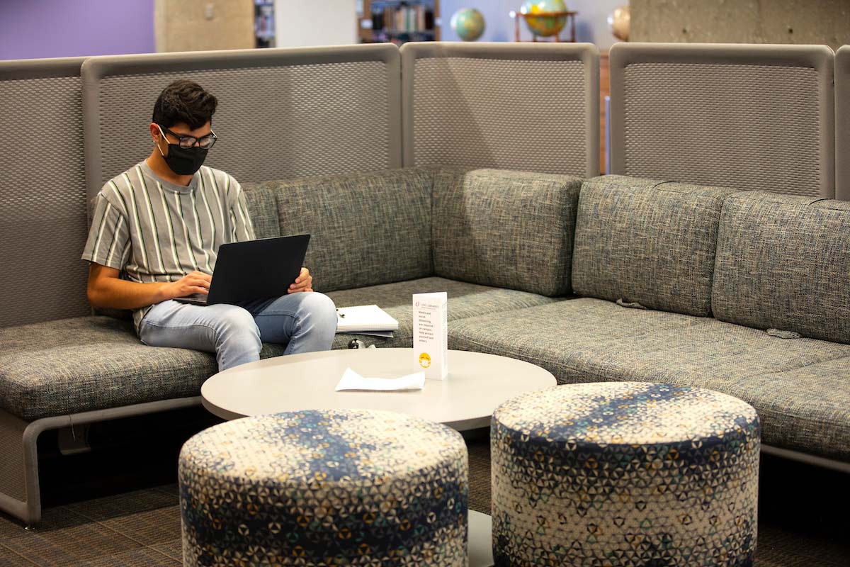 A student studies with a laptop at the Criss Library