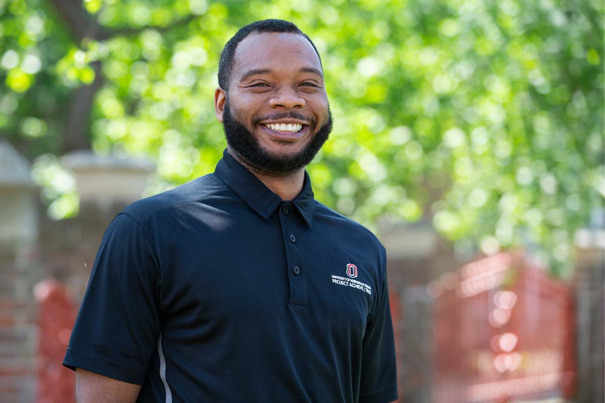 A photo of Shannon Teamer outside the Hayden House at UNO