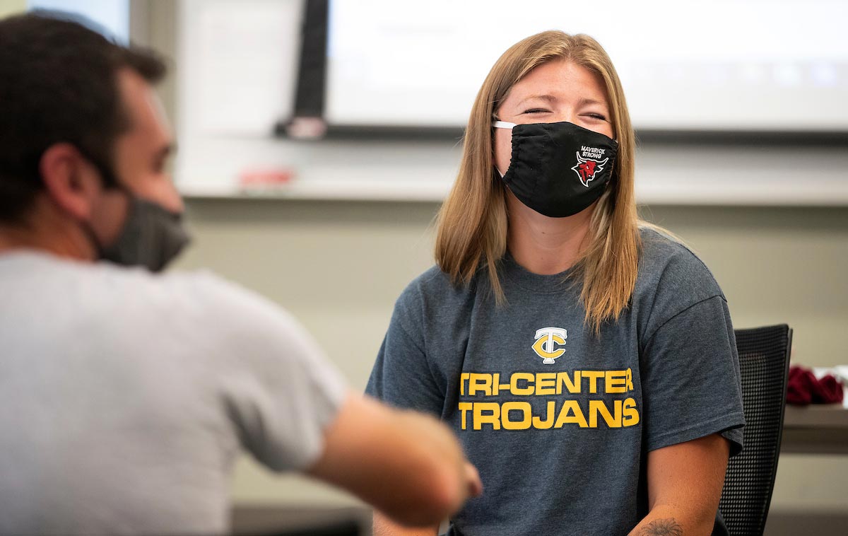 A student laughs from behind her Maverick Strong mask during a Teacher Education course.