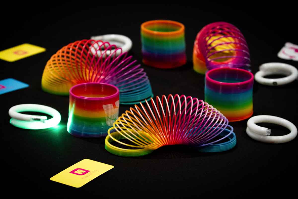 A photo of rainbow-colored items as table decorations from the Huespring kickoff.