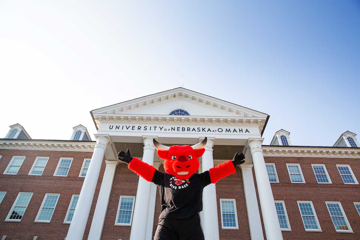 Durango poses for a photo in front of Arts and Sciences Hall