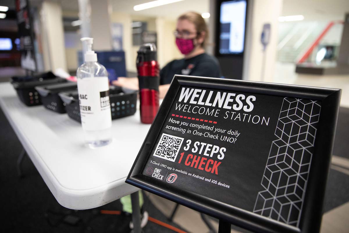 A student checks guests in at the Milo Bail Student Center Wellness Welcome Station.