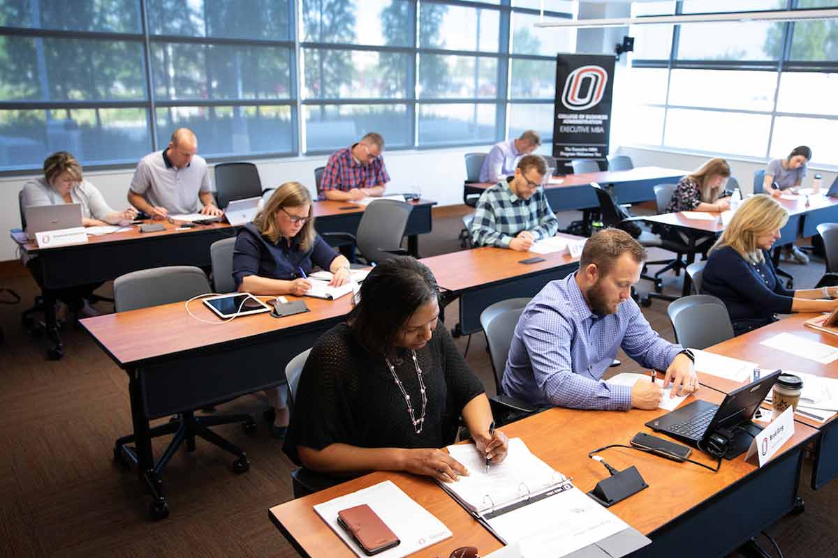Students study during a class held by UNO's Executive MBA program.