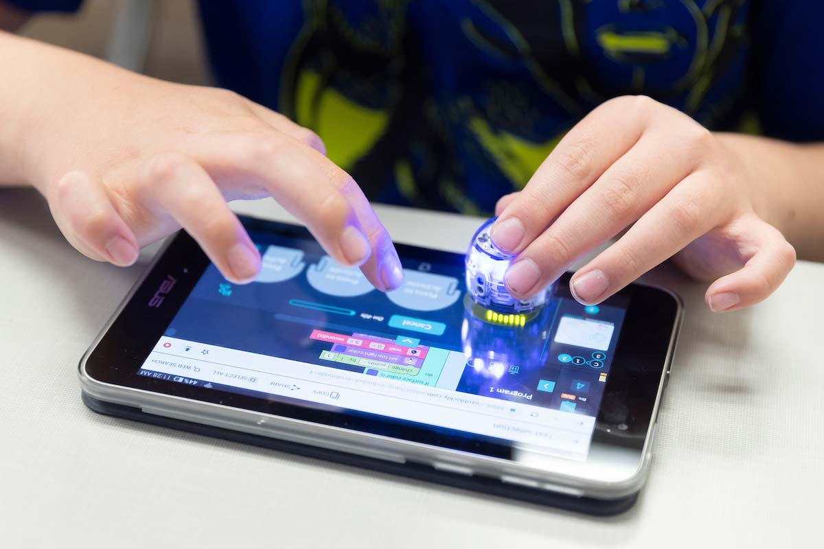 A student programs her robot at Techademy