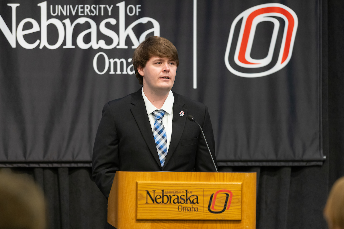 Nate Johnson speaks at a podium.