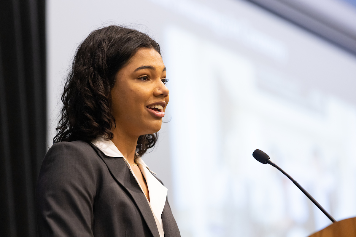 Tori Sims speaking at a podium. 