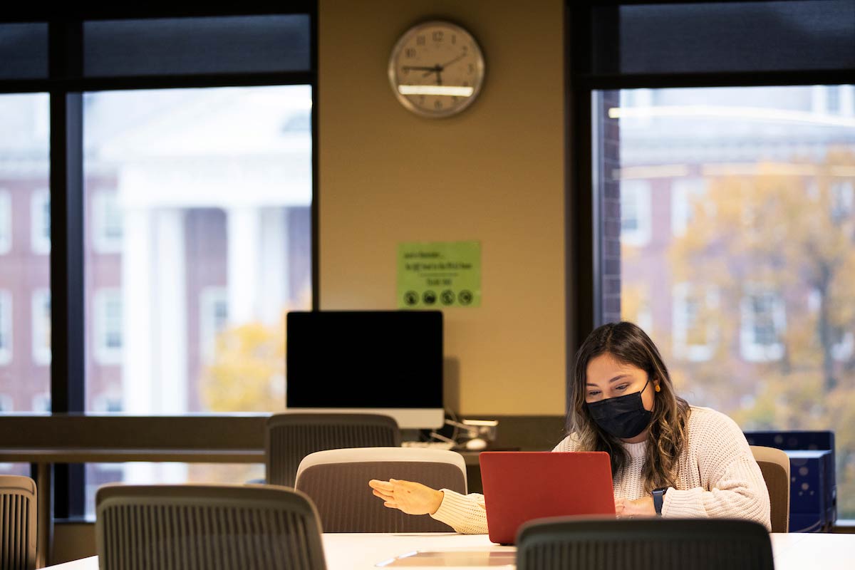 Junior Gabbi Calderon sits at a desk with her computer in front of her.