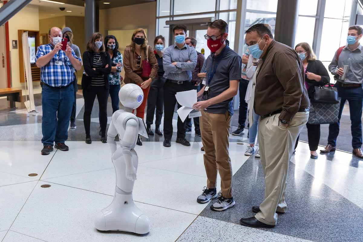 Legislative staffers look at robot used for artificial intelligence research.