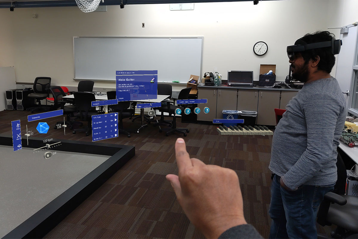 Mastorakis' research could lead to improvements in processing speed for devices like the Microsoft Hololens, seen in use here by a student and researcher navigating its menus.