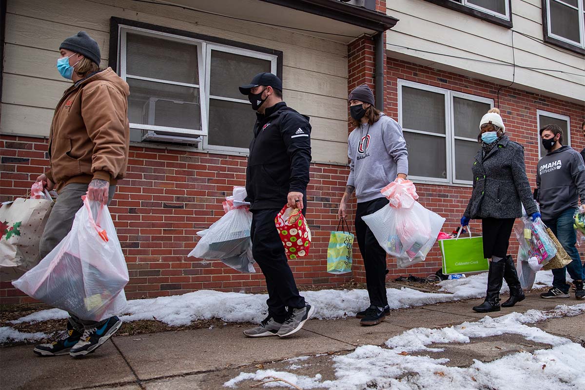 UNO student athletes delivered gifts to underserved communities as part of a partnership between Omaha Athletics and the Institute for Urban Development (4Urban.org), which includes helping identify DEAI-focused civic engagement activities for student athletes.