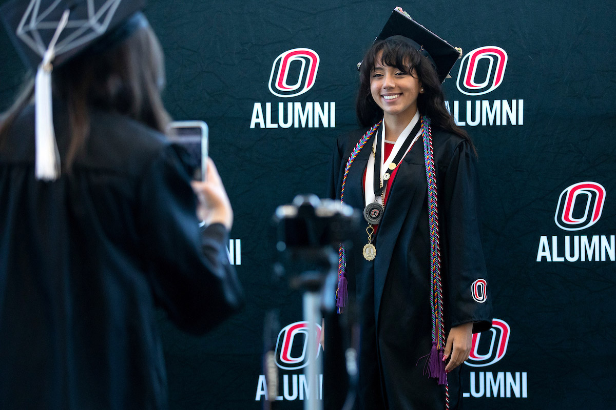 A graduate poses for a photo
