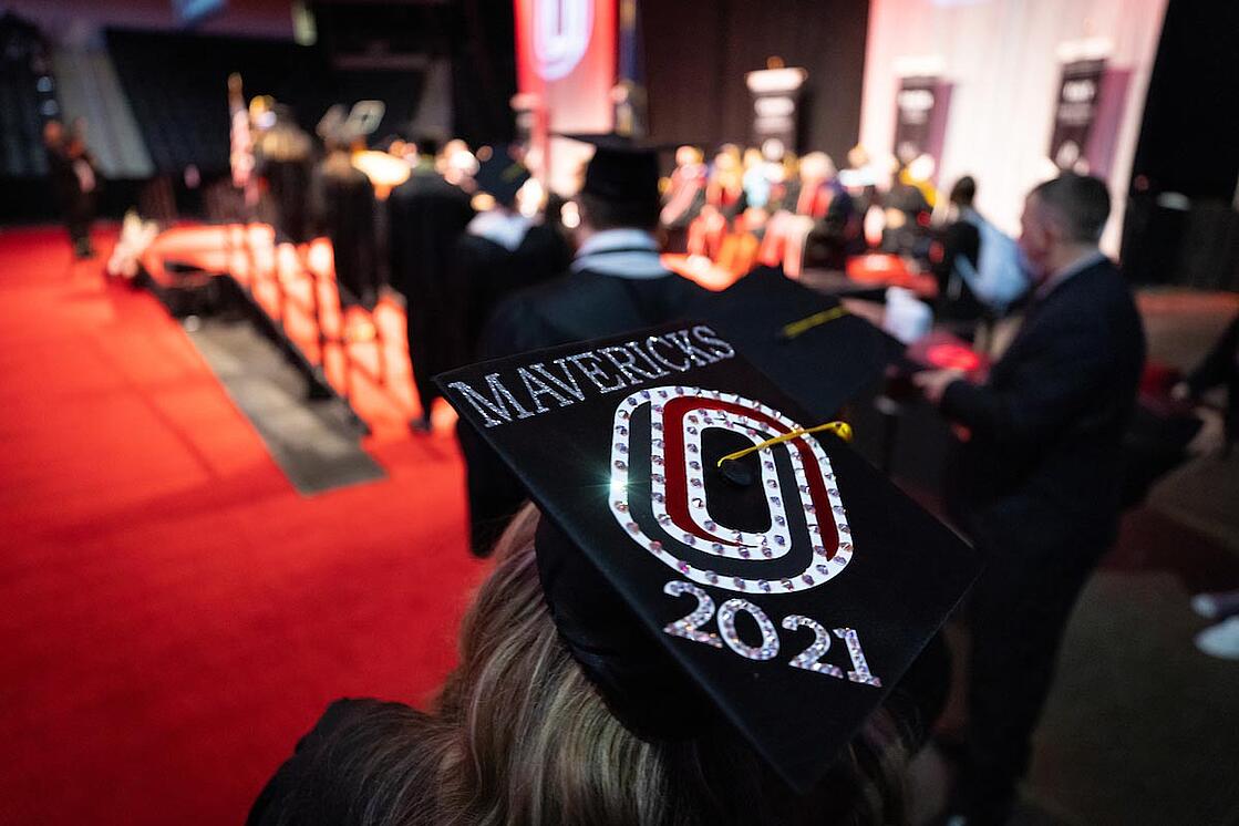 A graduate awaits her turn to cross the stage and receive her diploma at the December 2021 commencement ceremonies held by the University of Nebraska at Omaha (UNO).