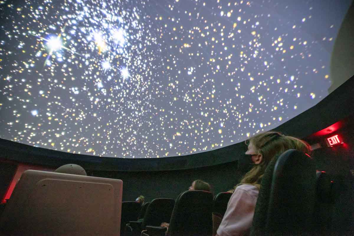 A group of Girl Scouts take in a planetarium show at UNO.