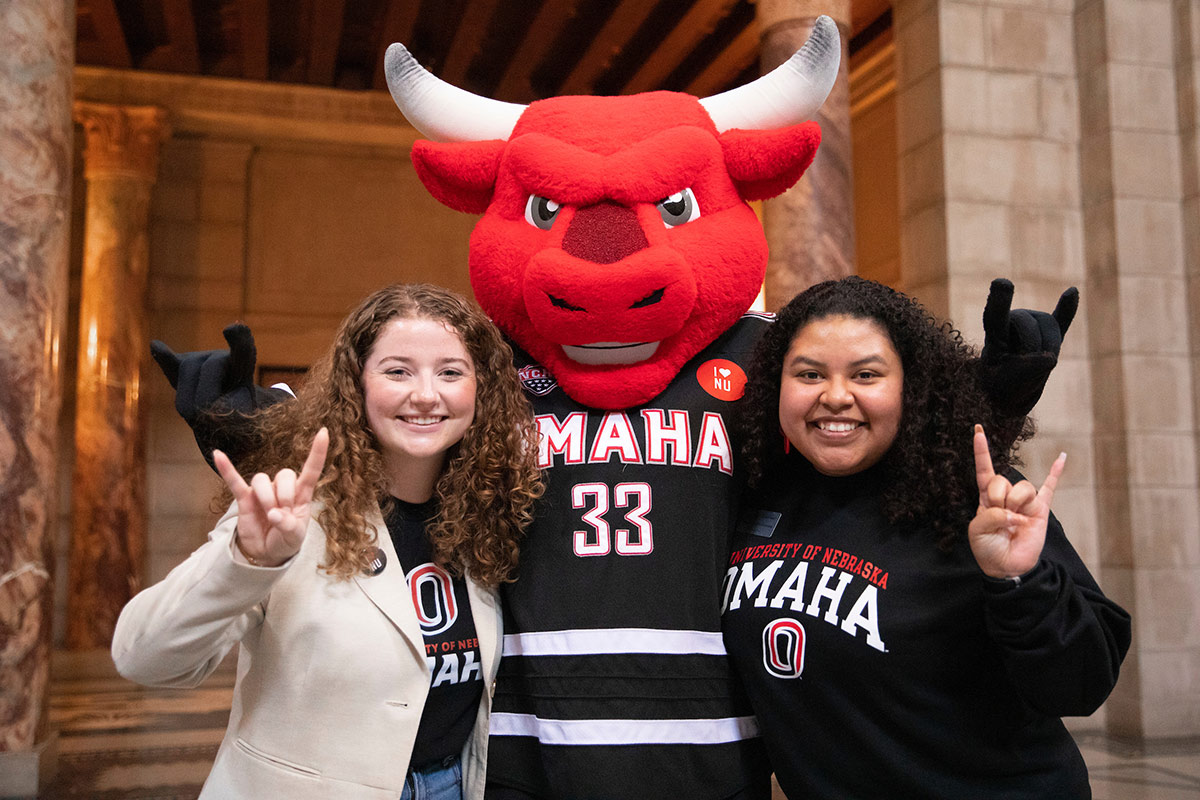 Student Body President and Student Regent Maeve Hemmer (left) and Vice President Amy Lopez Hernandez (right) pose with Durango at the Nebraska State Capitol during "I Love NU" Day.