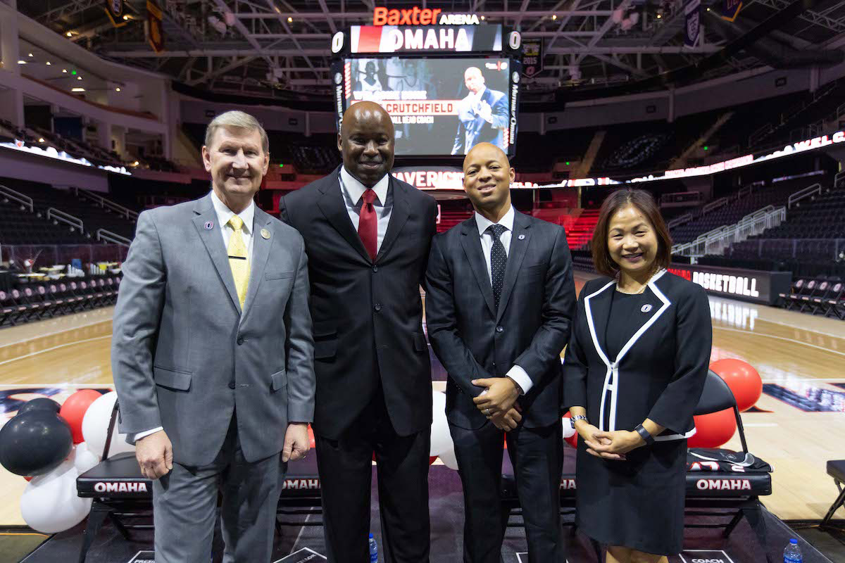 From left to right: University of Nebraska System President Ted Carter, Omaha men's basketball coach Chris Crutchfield, Vice Chancellor / Director of Athletics Adrian Dowell, and UNO Chancellor Joanne Li, Ph.D., CFA.