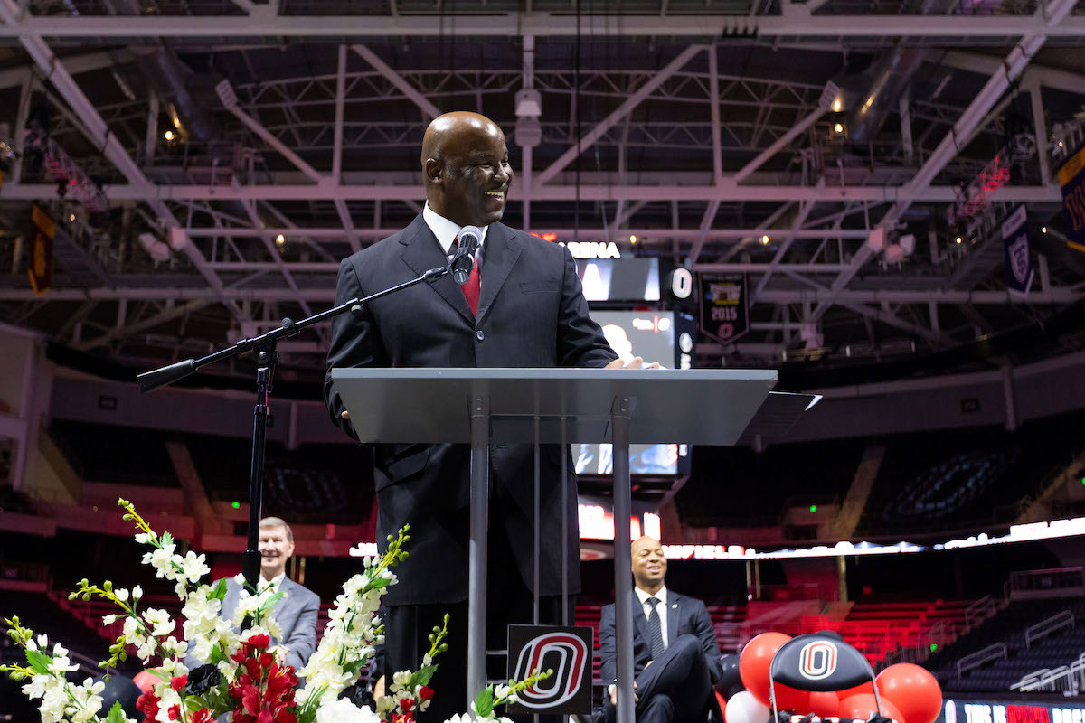 Omaha men's basketball coach Chris Crutchfield at the podium