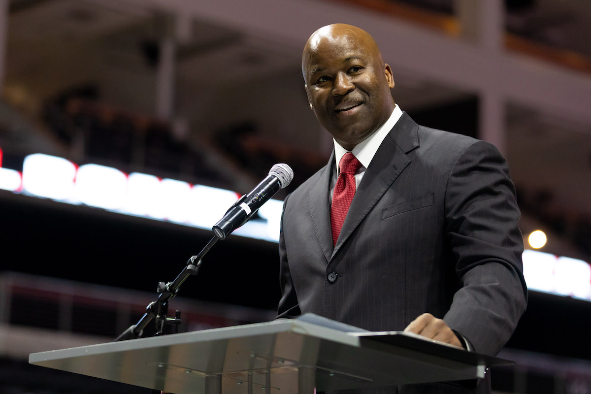 Omaha men's basketball coach Chris Crutchfield at the podium