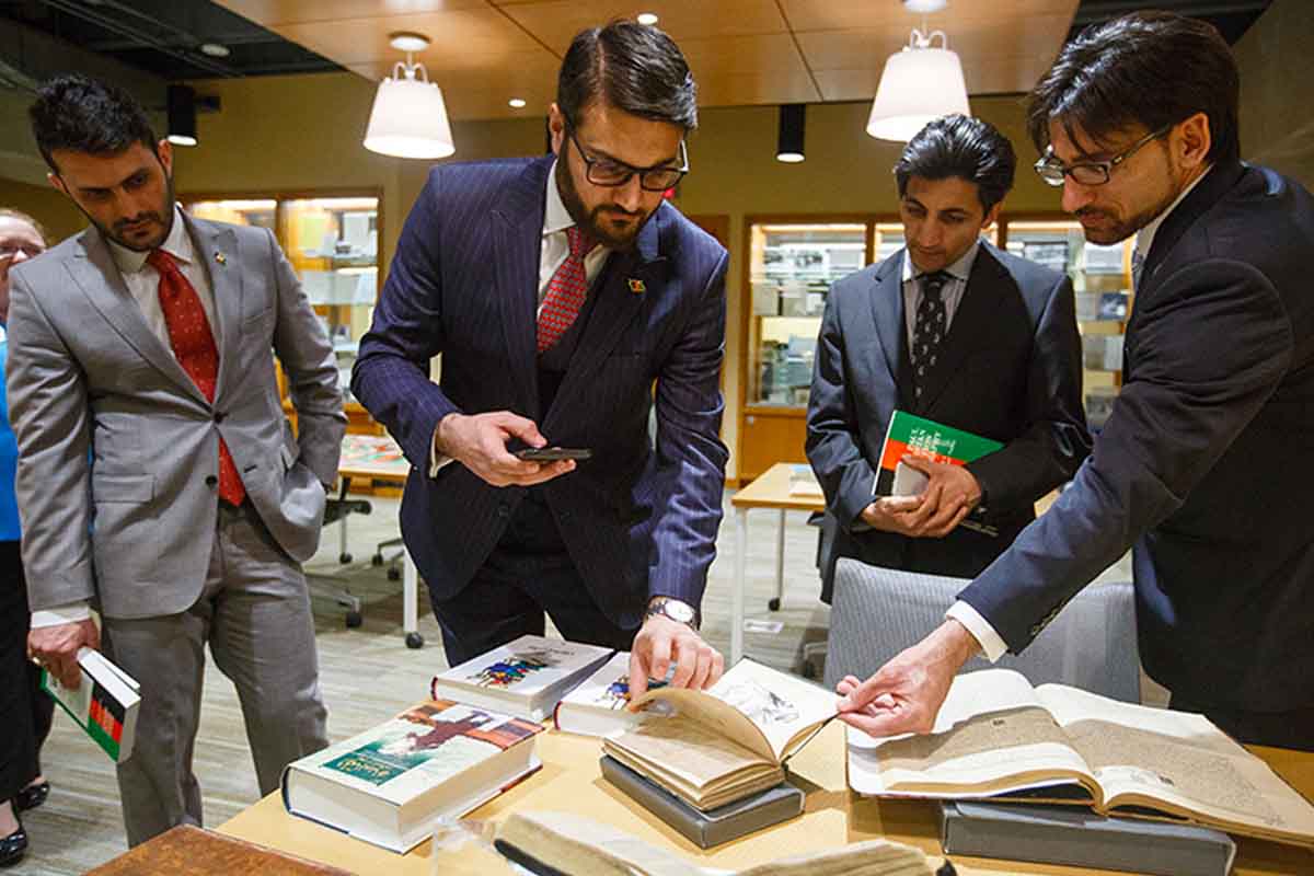 Afghanistan Ambassador to the U.S. Dr. Hamdullah Mohib explores UNO's collection at the Criss Library