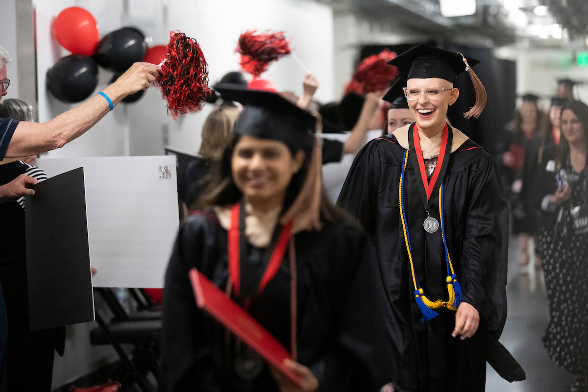 New graduates are greeted back stage by a tunnel of other UNO alumni.