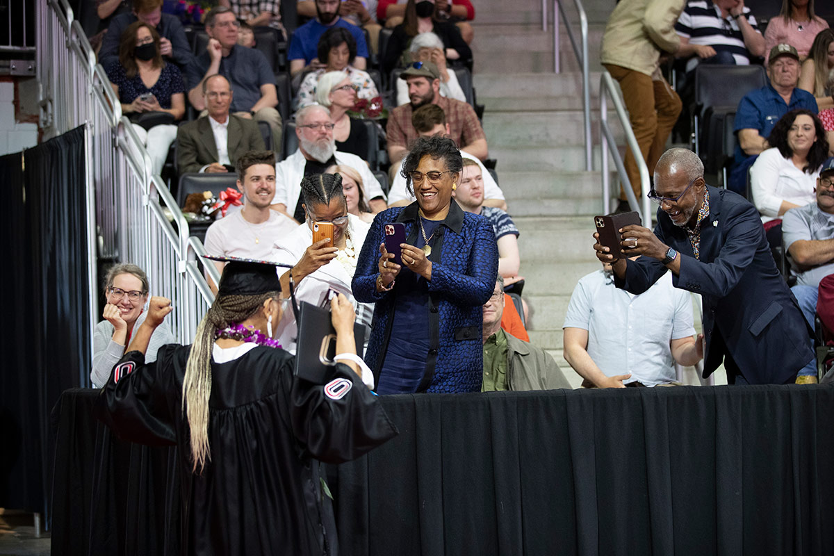 With diploma in hand, Adams greeted loved ones in the crowd celebrating her achievements.