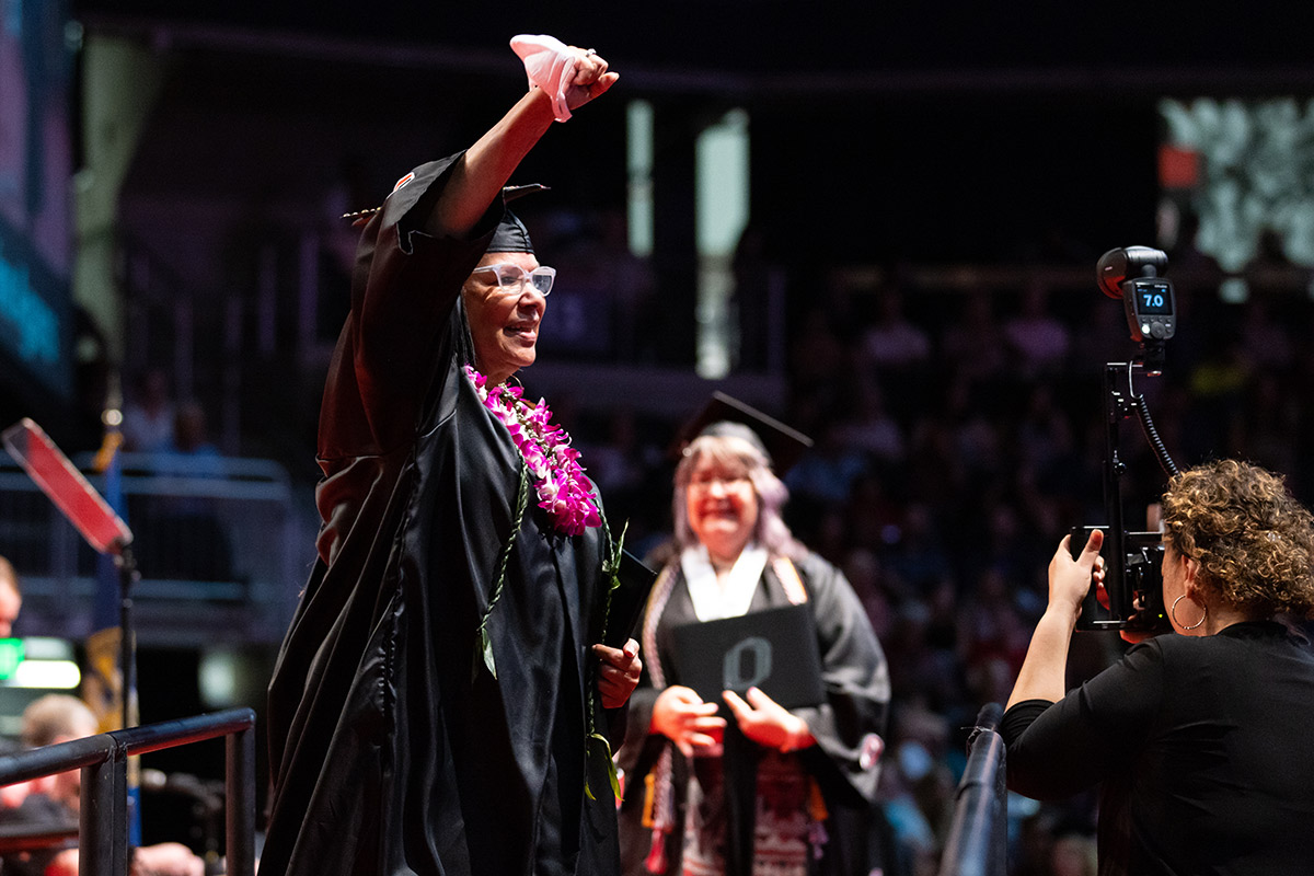 Adams walking across the stage with her diploma