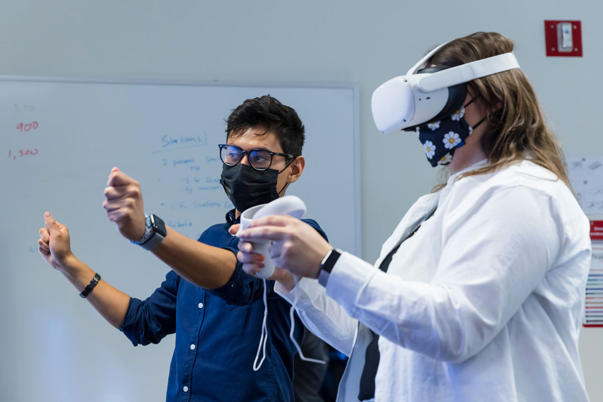 A professor and student use virtual reality in the classroom