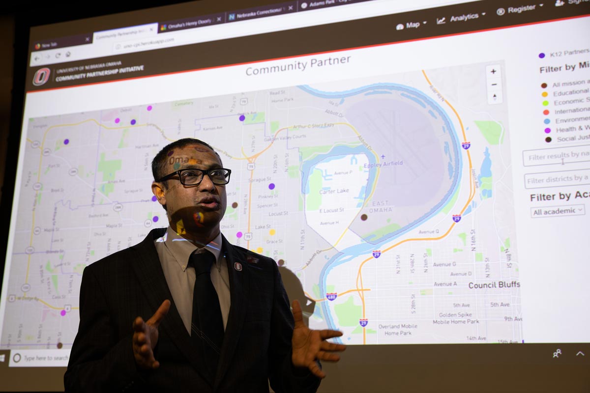 Sachin Pawaskar, Ph.D. in front of map graphic for CEPI