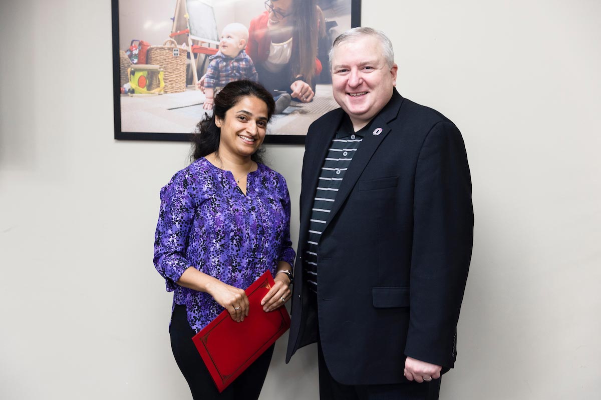 May Employee of the Month Jaisy Kumar stands next to Assistant Vice Chancellor for Human Resources Steve Kerrigan