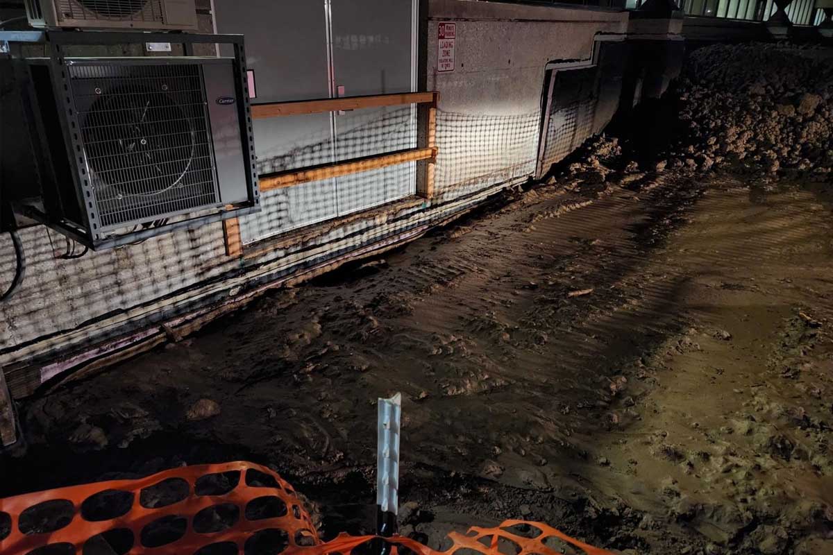 Piles of dirt from construction sit alongside the exterior of the Criss Library