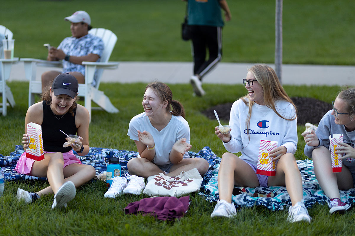 students laughing while eating ice cream and popcorn