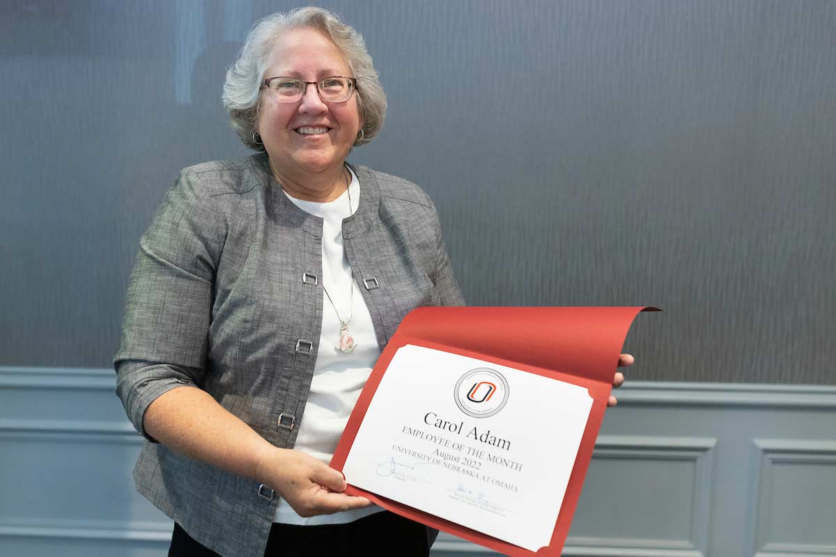 Carol Adam holds her "Employee of the Month" certificate.