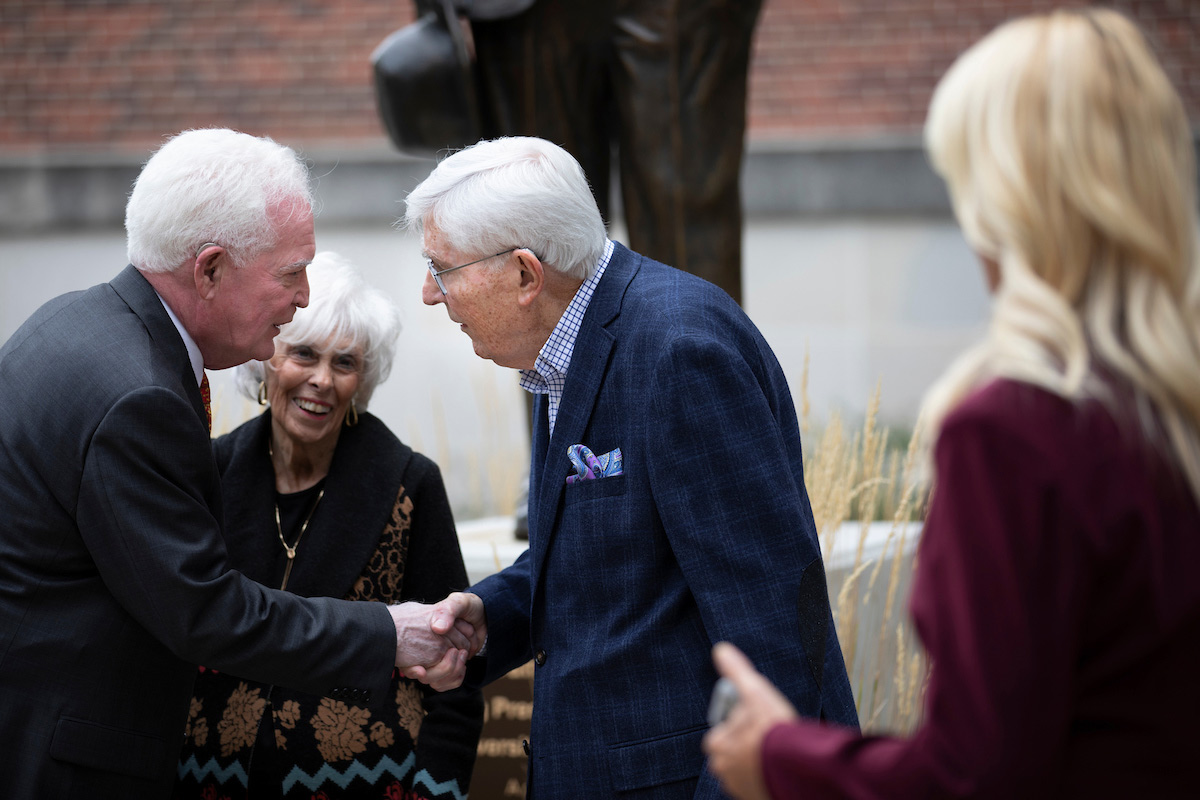 Daniel Jenkins, the grandson of Rev. Daniel E. Jenkins, UNO’s first president, left, greets Beverly and Al Thomsen.