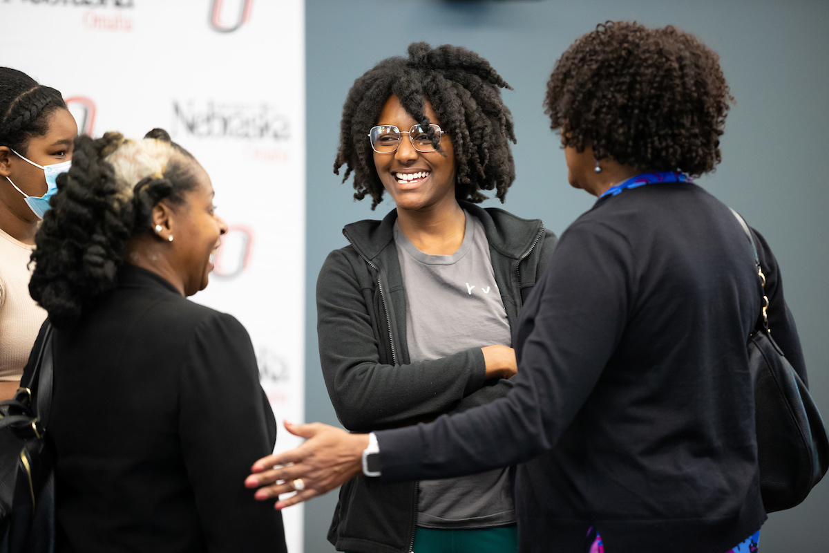 Individuals chat at the event.