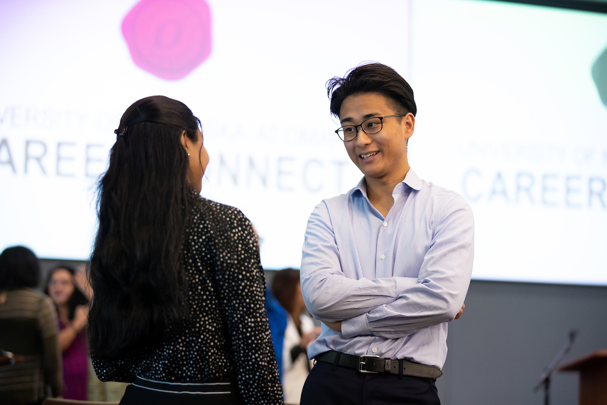 Individuals chat at the event.