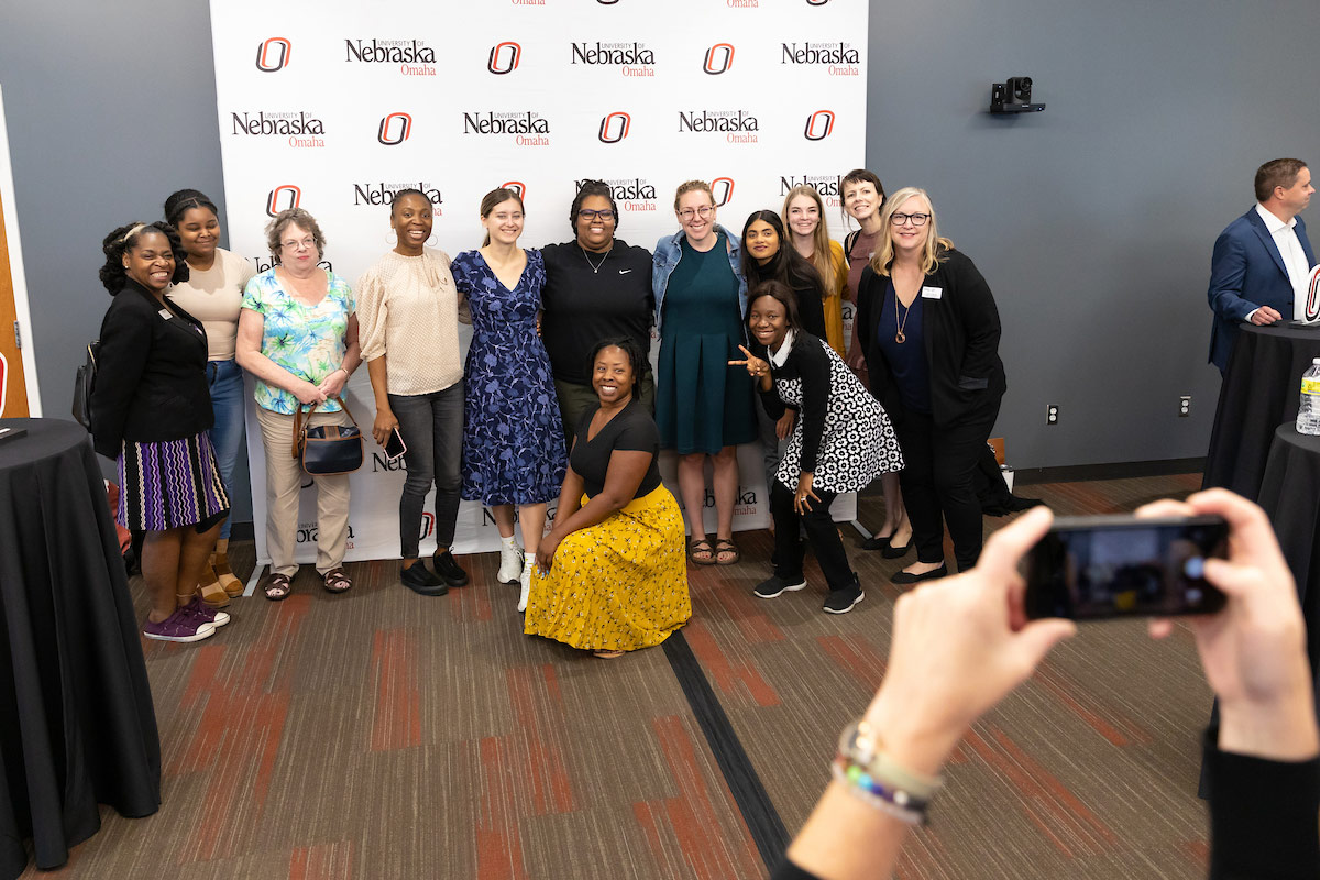 Students, faculty, staff, and community members pose at the event.