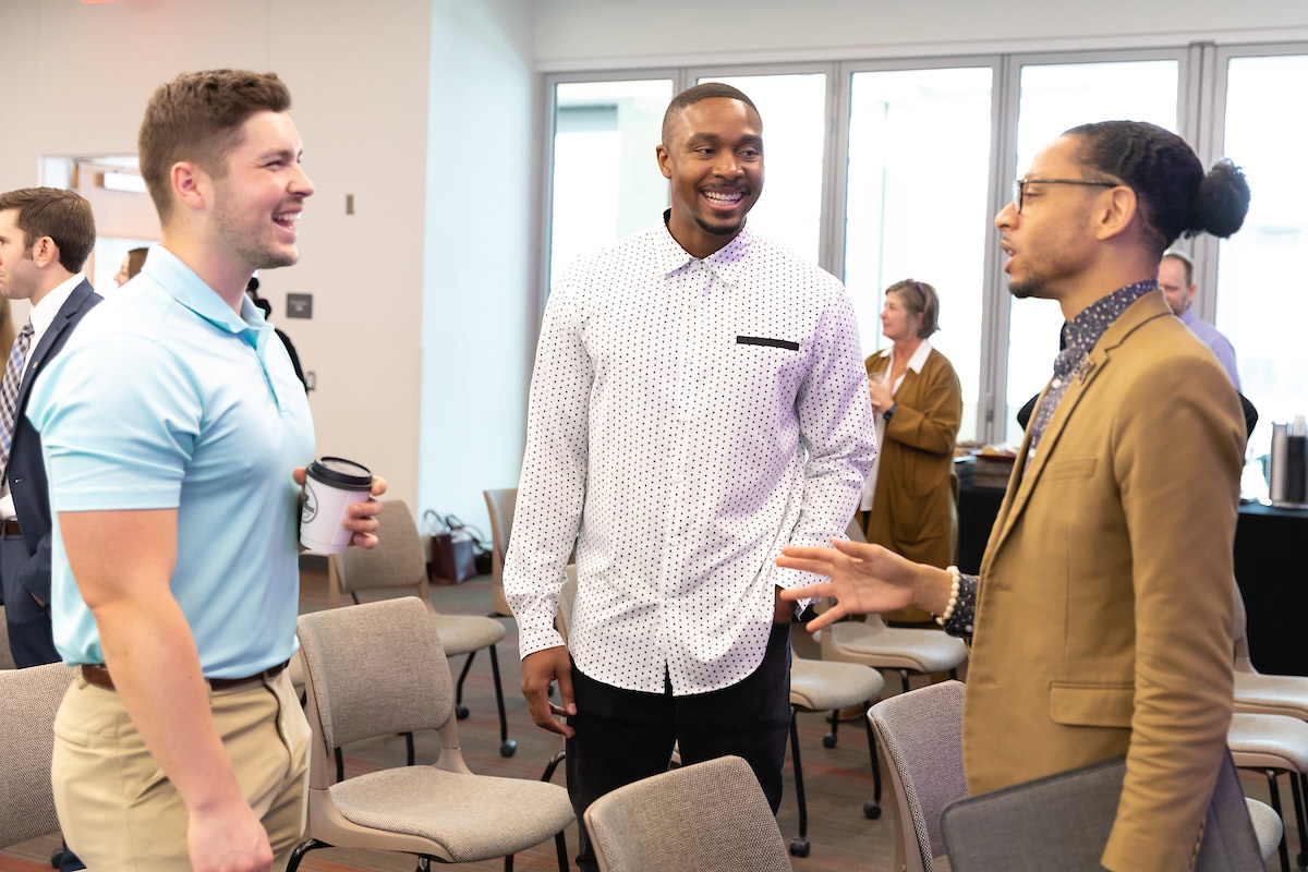 Individuals chat at the event.