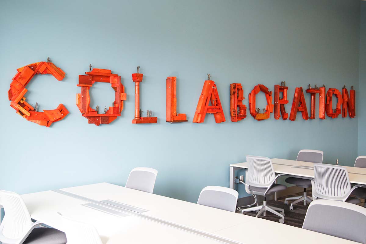 An orange sign in the Barbara Weitz Community Engagement Center that reads "Collaboration"