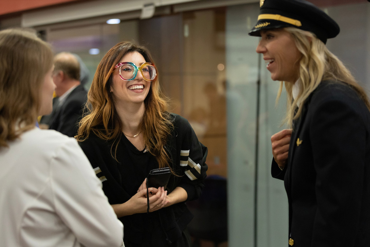 United Airlines pilot Monica Frain, right, speaks with UNO aviation students. 