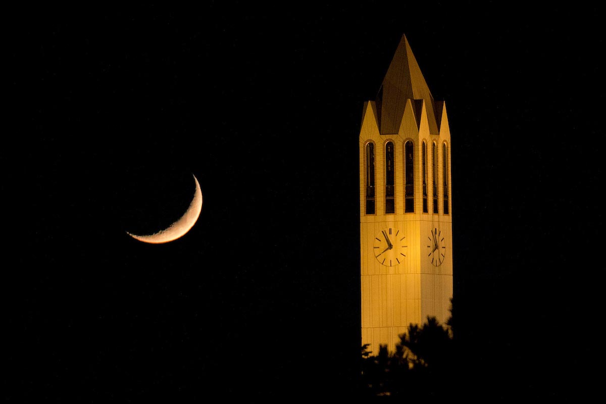 A moon rise is cast over the Henningson Memorial Campanile