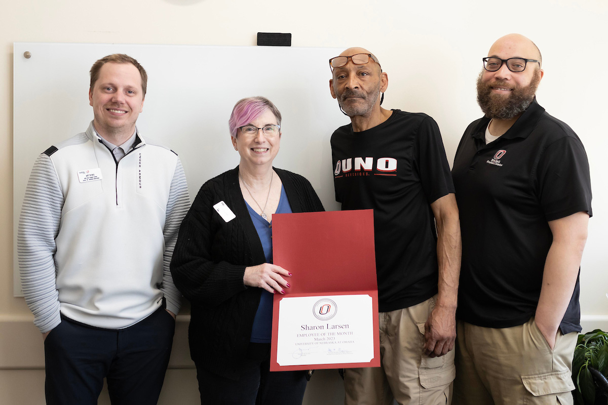 Sharon Larsen posing with her coworkers