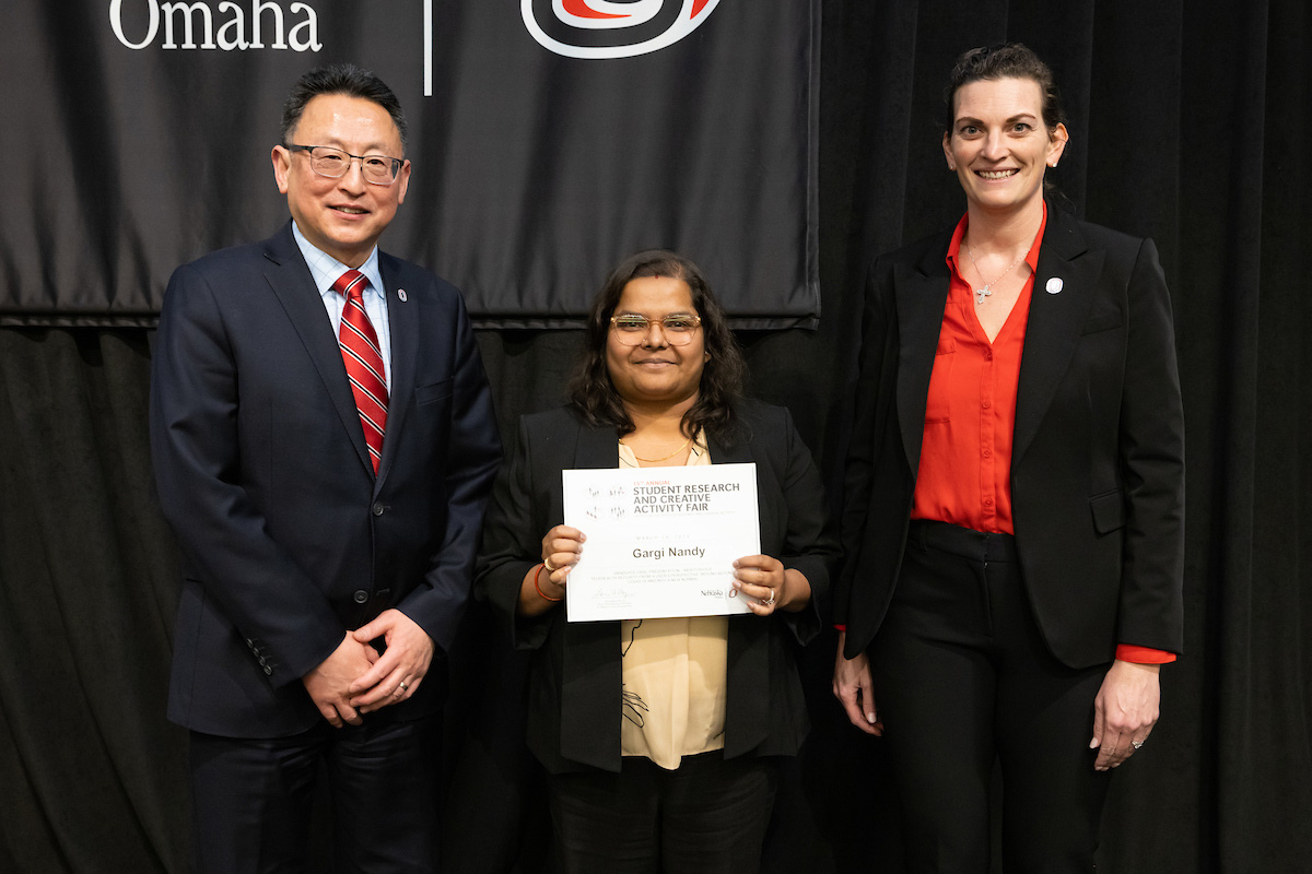 award recipient poses at the Student Research and Creative Activity Fair