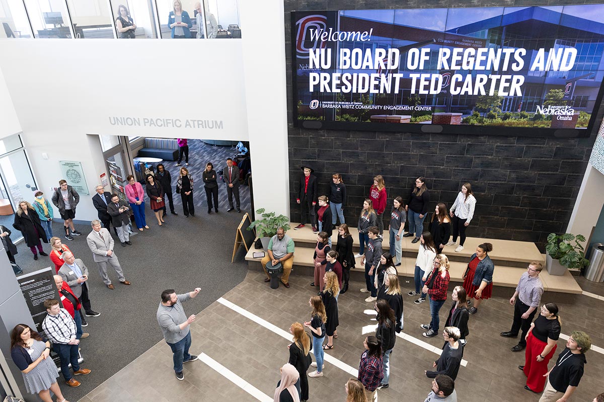 Members of the University of Nebraska Board of Regents listen to a performance by the UNO Concert Choir during a visit to the Barbara Weitz Community Engagement Center.