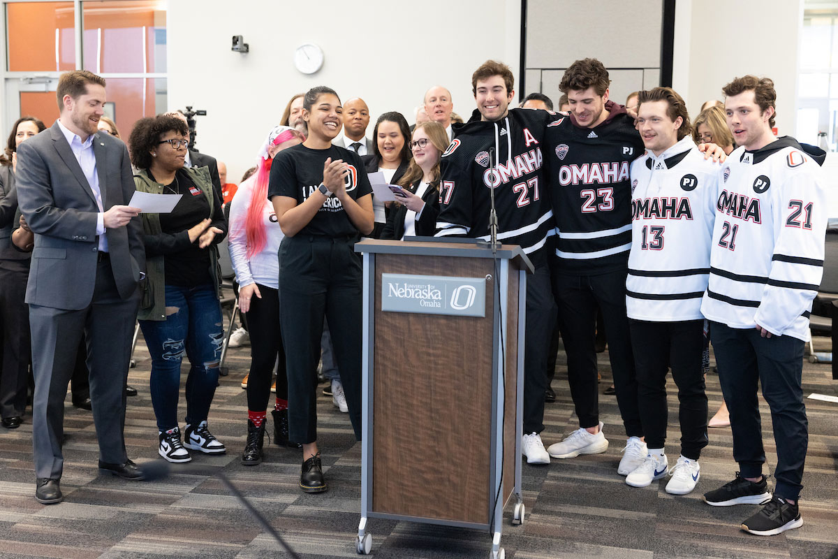 Omaha Hockey players, Vice Chancellor of Athletics Adrian Dowell, and others sing the UNO fight song.