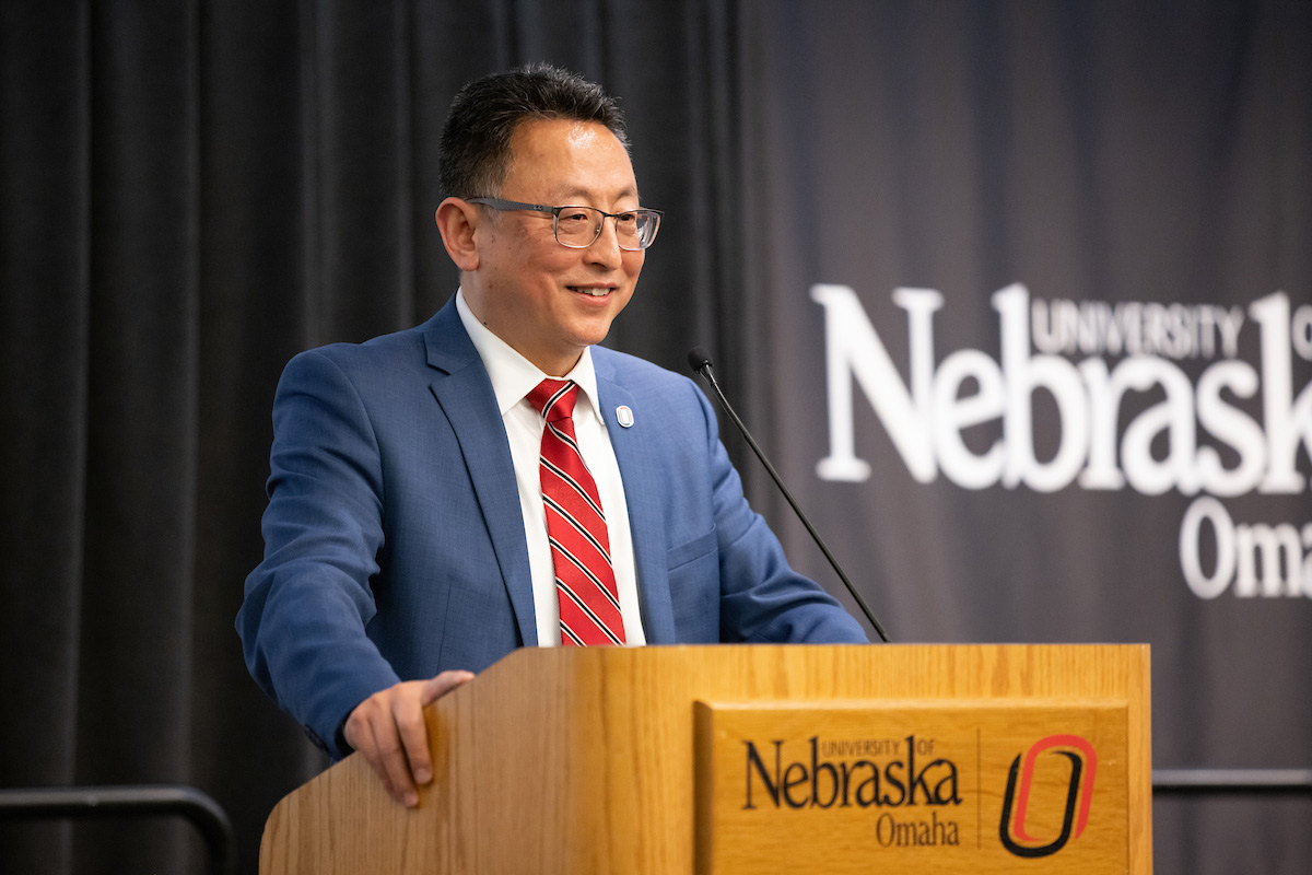 Phil He, Ph.D. at the podium