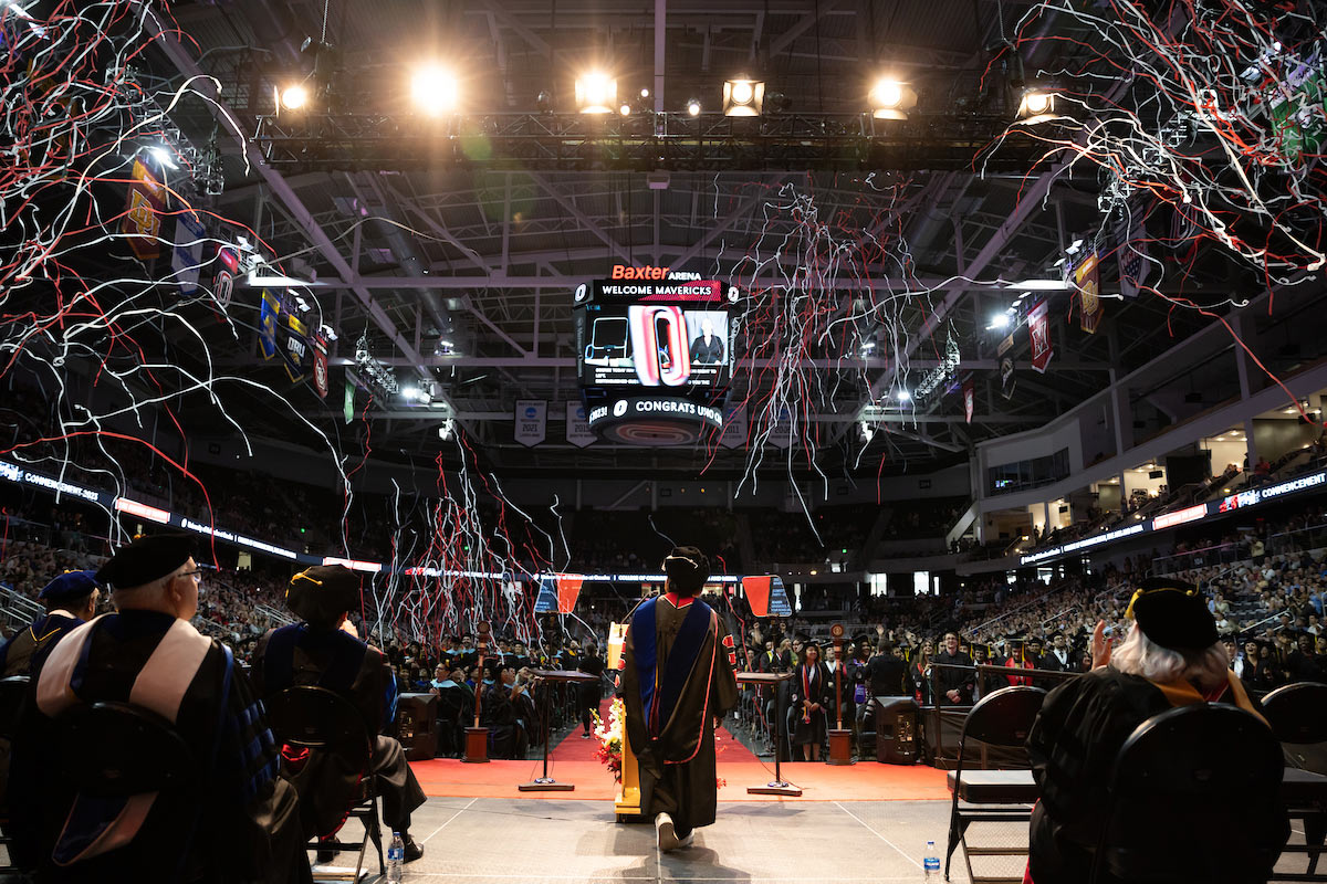 Confetti fills the air as the camera captures the arena from behind the stage