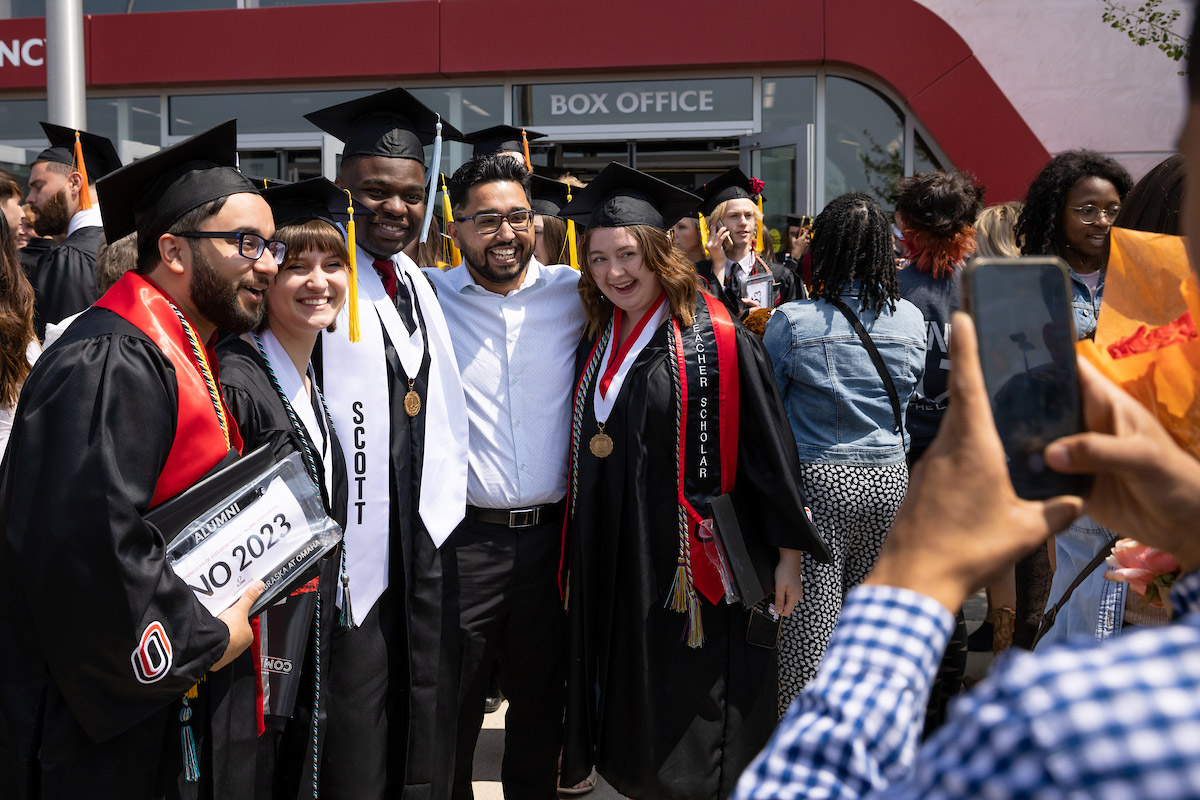 Graduates, friends, and family celebrate outside of Baxter Arena